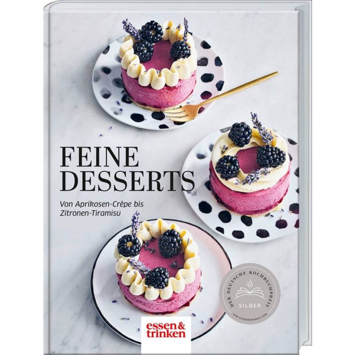 Buchcover: "Feine Desserts". Drei Himbeertörtchen mit Brombeeren und Sahne auf gepunkteten Tellern, verziert mit Lavendel. Text: "Von Aprikosen-Crêpe bis Zitronen-Tiramisu". Logo: essen & trinken.