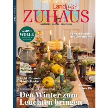 Titelbild der Zeitschrift „Landlust Zuhause“, Winter 2022; festlich gedeckter Tisch mit Kerzen, Zweigen, Quitten und Tee; Texte zu Themen wie Wohnen im Holzhaus, warme Wolle und Laternen aus Eis.