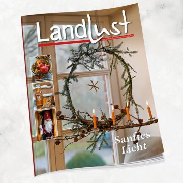 Titelseite der Zeitschrift „Landlust“, Ausgabe November/Dezember 2024, mit weihnachtlicher Dekoration aus Naturmaterialien, vier brennenden Kerzen, Tannenzweigen und Sternmotiv.