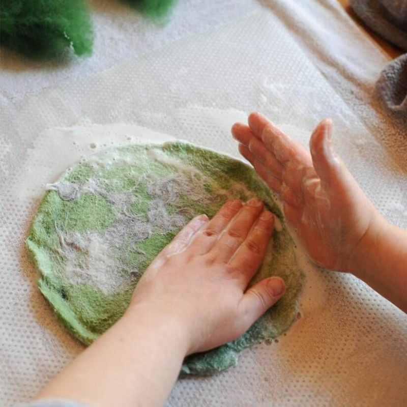 Ein Tannenbäumchen wird gefilzt. Danach wird die Wolle eingeseift